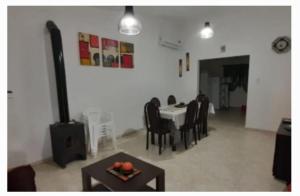 a dining room with a table and chairs and a tableablish at El Tito Alojamiento in San Roque