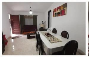 a dining room with a white table and chairs at El Tito Alojamiento in San Roque
