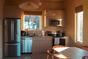 a kitchen with a refrigerator and a table in it at trekløveren in Covington