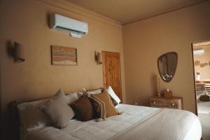 a bedroom with a bed with pillows and a air conditioner at trekløveren in Covington