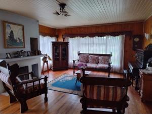 a living room with a couch and a fireplace at B&B La Posada del Colono in Puerto Clocker