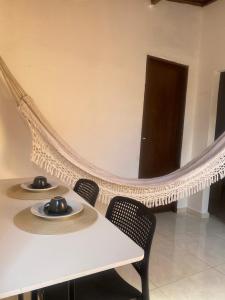 a white table with two hats on top of it at BARRA NOVA CASCAVEL CEARÁ-Casa Solaris in Cascavel +4 photos