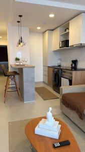 a kitchen and a living room with a table at Lujoso Apartamento en edificio frente a la playa San José! in Encarnación