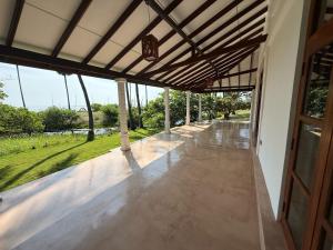a view from the porch of a house with a patio at 108 Palms Beach Resort in Trincomalee