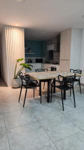 een tafel en stoelen in een kamer met een keuken bij Departamentos Hilario Lagos in Viedma