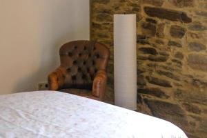 a bedroom with a chair and a table and a lamp at Sobreiro's Villa in Douro Valley in Mesão Frio +44 photos