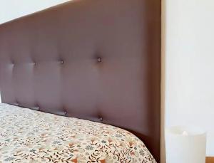 a bed with a brown headboard in a bedroom at Sobreiro's Villa in Douro Valley in Mesão Frio