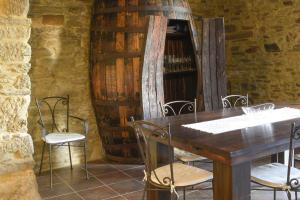 a table and chairs in a room with a wine cellar at Sobreiro's Villa in Douro Valley in Mesão Frio