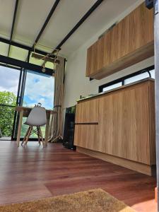 a living room with wooden cabinets and a table at Equilibrium glamping in Guarne +24 photos