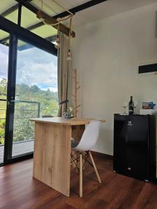 a kitchen with a table and a chair and a window at Equilibrium glamping in Guarne