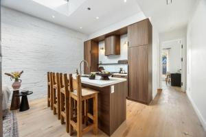 a kitchen with a sink and wooden cabinets at The Brick Hotel - The Loft in Toronto