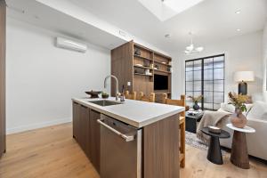 a kitchen with a sink and a living room at The Brick Hotel - The Loft in Toronto +19 photos