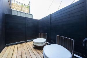 a balcony with two toilets on a wooden deck at The Brick Hotel - The Second Suite in Toronto