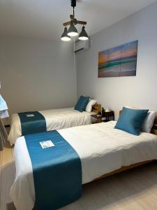 En eller flere senge i et værelse på Value Residence Hotel 久貝