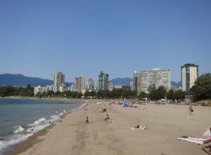 a group of people on a beach near the water at Charming Bright 3BR House - Upper Level Suite in Burnaby