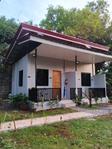 a small white house with a red roof at LIBYA's Guesthouse in San Juan +6 photos