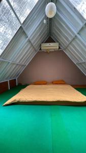 a room with a bed in a tent at camping camp in Ciater