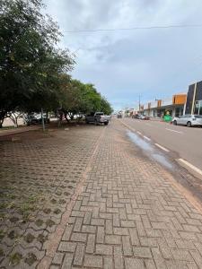 a cobblestone street with cars parked on the side of the road at Atalaia Apart in Sinop