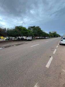 an empty highway with cars parked on the side of the road at Atalaia Apart in Sinop