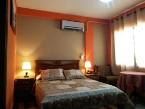 a hotel room with a bed and a window at Hotel Piesta in Trinidad