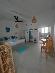 a living room with a bed and a table and chairs at Amma's Garden in Unawatuna