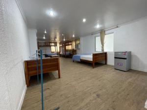 a bedroom with a bed and a desk in a room at SARDINEBAY Dive Resort in Moalboal