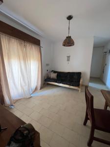 a living room with a couch and a table at Polimar in Mar de Ajó