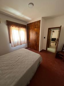 a bedroom with a large bed and a mirror at Polimar in Mar de Ajó