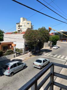 two cars parked on a street with a traffic light at Polimar in Mar de Ajó
