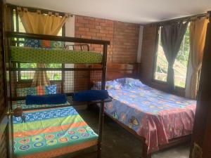 a bedroom with two bunk beds and a window at Casa Lucy in Yumbo
