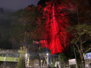 a red lighted mountain at night with a building at Suite Matrimonial 3plz con cocina y garage in Baños