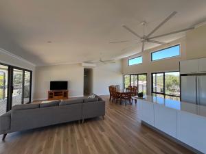 a large living room with a couch and a television at Moore Memories Beach House in Guilderton