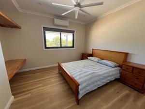 a bedroom with a bed and a window at Moore Memories Beach House in Guilderton +19 photos