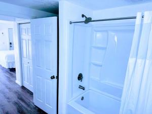 a bathroom with a shower and a white door at Cozy Twilight Hideaway in Forks