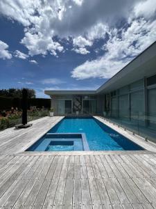 a swimming pool on a deck next to a building at Portsea Paramount - When only the best will do in Portsea