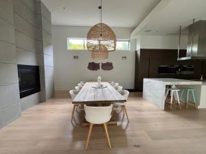 a dining room with a table and chairs in a kitchen at Portsea Paramount - When only the best will do in Portsea