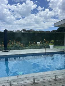 a large swimming pool in a yard with a garden at Portsea Paramount - When only the best will do in Portsea +1 photo