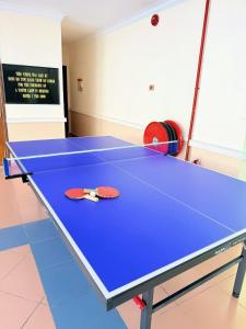 a ping pong table in a room with at Met Blue Ocean Resort in Mersing