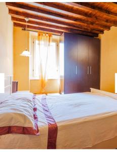 a bedroom with a large bed with a large window at Dimora del Viaggiatore Montecatini Terme in Serravalle Pistoiese