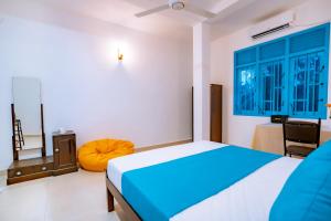 a bedroom with a bed and a chair in it at 75 Inn Madiha in Matara