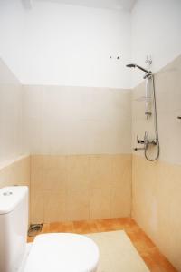 a bathroom with a toilet and a shower at 75 Inn Madiha in Matara +9 photos