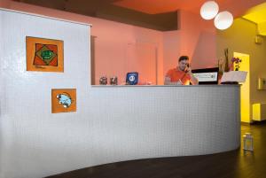 a man sitting at a counter in a restaurant at Hotel Casablanca in Rimini