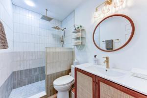a bathroom with a toilet and a sink and a mirror at Independence Bungalow in Wimberley +12 photos