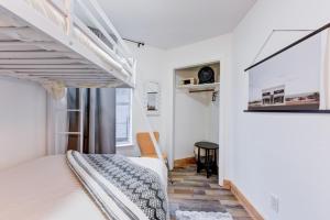 a bedroom with two bunk beds and a window at Independence Bungalow in Wimberley