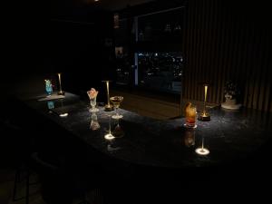 a table with wine glasses and candles on it at APA Hotel Kanazawa Ekimae in Kanazawa