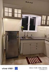 a kitchen with a stainless steel refrigerator and a sink at JOHNs' Paradise - Homestay in Cochin