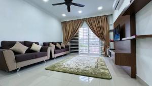 a living room with a couch and a tv at PICC Seruling Precinct 5, 62200 Putrajaya 3BR Homestay in Putrajaya +24 photos