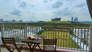 a table and chairs on a balcony with a view at PICC Seruling Precinct 5, 62200 Putrajaya 3BR Homestay in Putrajaya