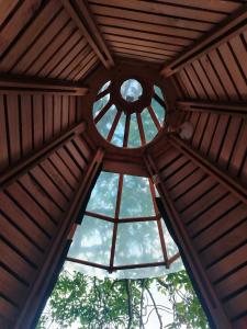 a wooden ceiling with a window in a wooden building at Tipi Miramelinda in Baños +3 photos
