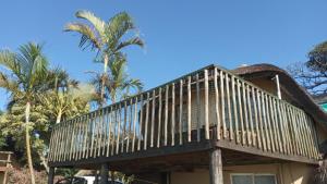 a house with a deck on top of it at Angers Aweigh, Hibberdene Chalet 86 in Hibberdene
